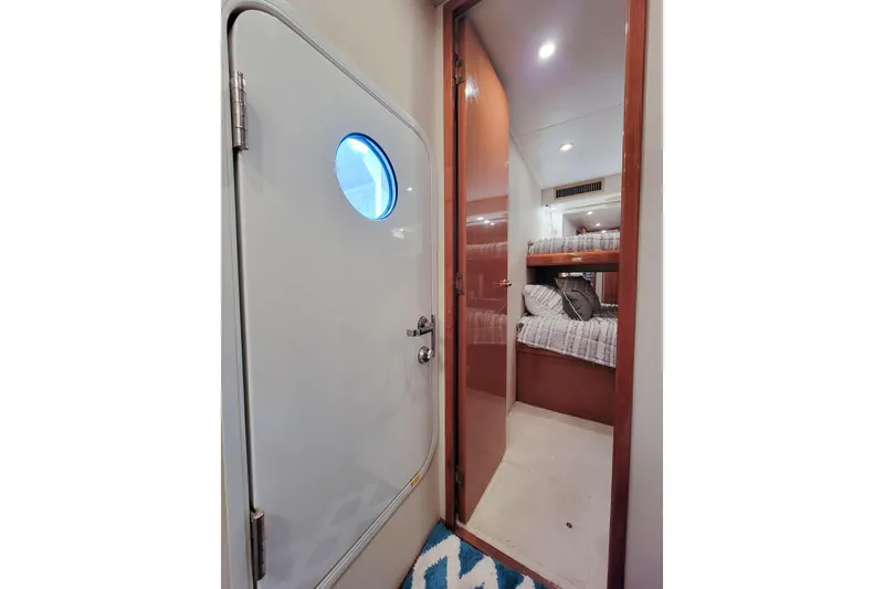 Slide: The Image of Interior of 2002 Viking 65 Enclosed Bridge yacht, showing cabin with bunk beds. - 82