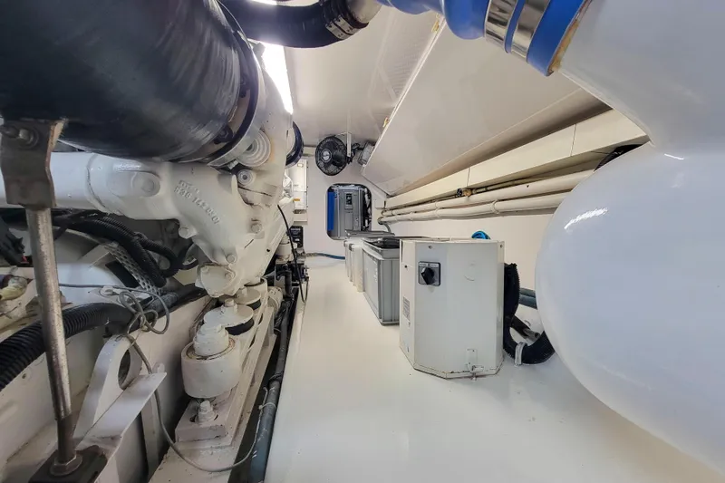Slide: The Image of Engine room of 2002 Viking 65 Enclosed Bridge yacht, showcasing machinery and equipment. - 95