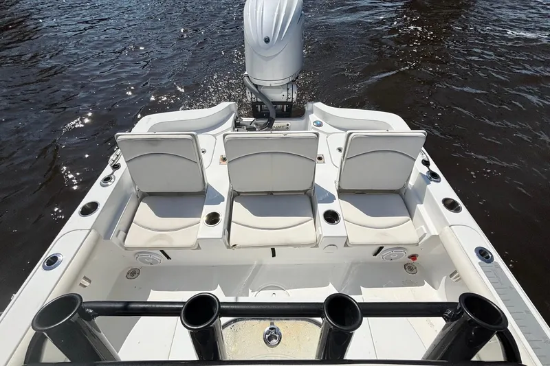 Slide: The Image of 2023 Sea Hunt BX 25 FS boat with seating and rod holders on the water. - 14