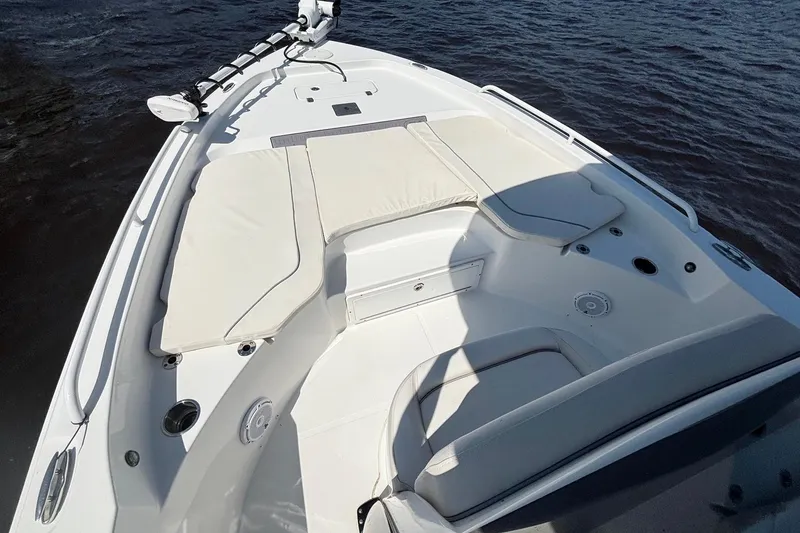 Slide: The Image of 2023 Sea Hunt BX 25 FS boat interior with cushioned seating and water view. - 16