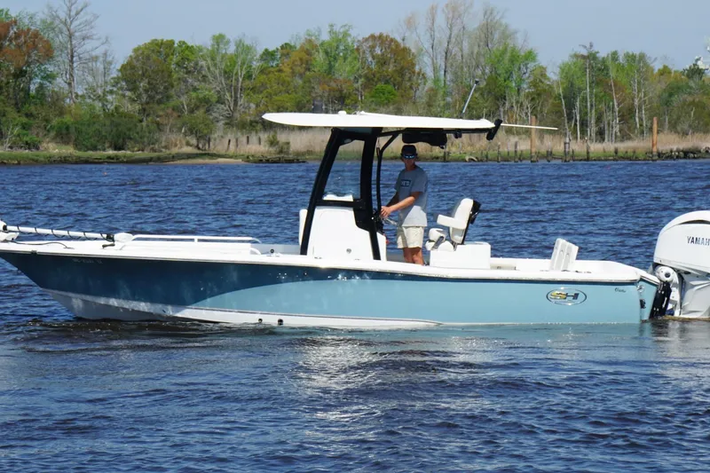 Slide: The Image of 2023 Sea Hunt BX 25 FS boat on water, featuring sleek design and Yamaha engine. - 8