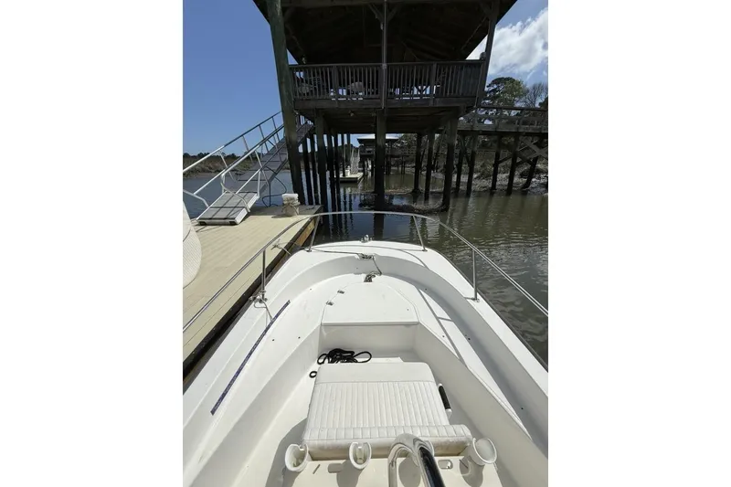 Slide: The Image of 2016 Boston Whaler 170 Montauk docked near wooden pier under clear sky. - 14
