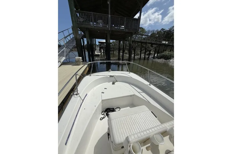 Slide: The Image of 2016 Boston Whaler 170 Montauk boat docked near wooden pier under blue sky. - 15