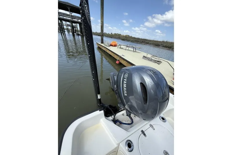 Slide: The Image of 2016 Boston Whaler 170 Montauk with Yamaha engine docked by a wooden pier. - 19