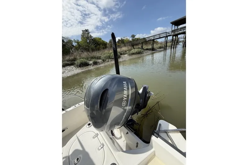Slide: The Image of 2016 Boston Whaler 170 Montauk with Yamaha outboard motor near wooden dock. - 20