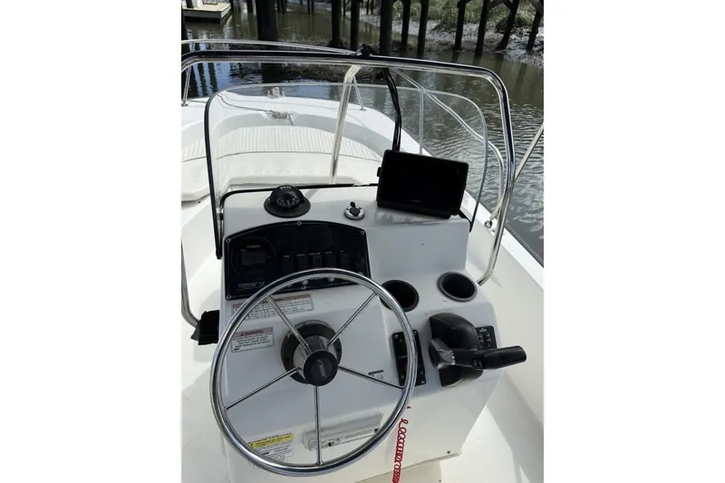 Slide: The Image of 2016 Boston Whaler 170 Montauk boat console with steering wheel and controls. - 6