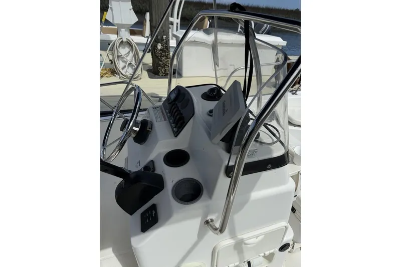 Slide: The Image of 2016 Boston Whaler 170 Montauk boat console with steering wheel and controls. - 8