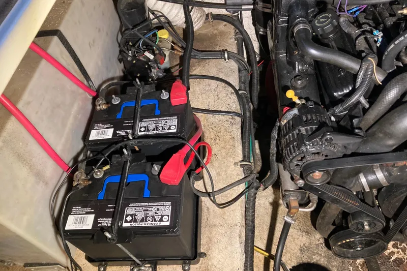 Slide: The Image of Engine compartment of 2003 Rinker Fiesta Vee 270 with dual batteries and wiring. - 10