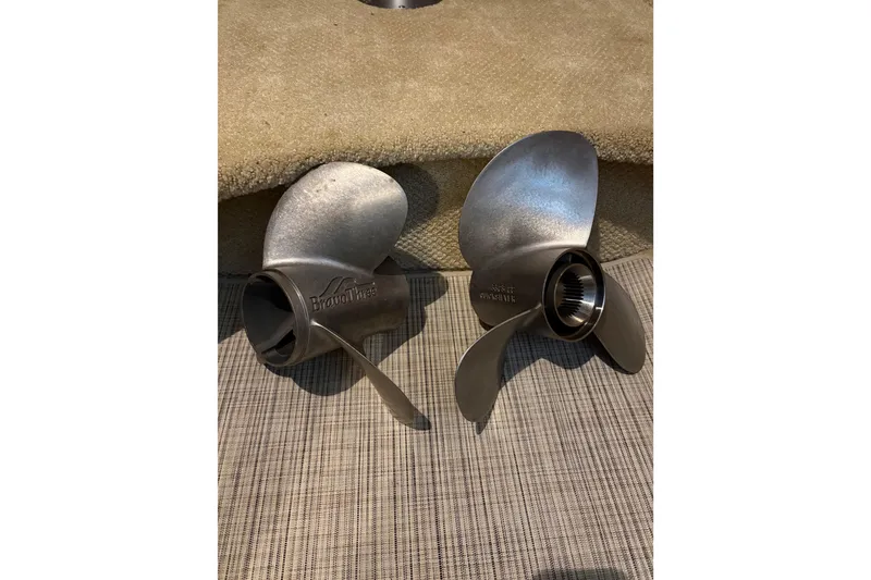 Slide: The Image of Stainless steel boat propellers for 2003 Rinker Fiesta Vee 270 on carpeted surface. - 12