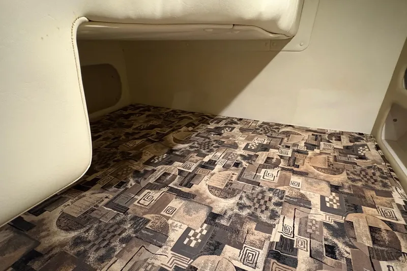 Slide: The Image of 2003 Rinker Fiesta Vee 270 cabin interior with patterned flooring. - 13