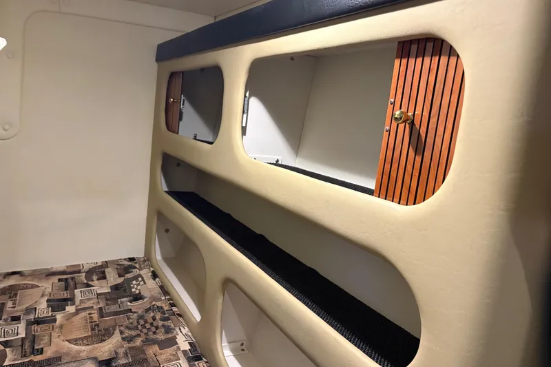 Slide: The Image of Interior cabin of 2003 Rinker Fiesta Vee 270 boat with storage compartments. - 24