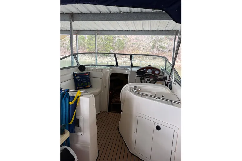 Slide: The Image of 2003 Rinker Fiesta Vee 270 boat interior with helm and seating under canopy. - 26