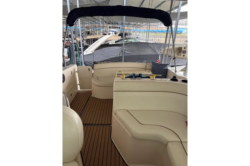 Slide: The Image of 2003 Rinker Fiesta Vee 270 boat interior with beige seating and wood flooring. - 29