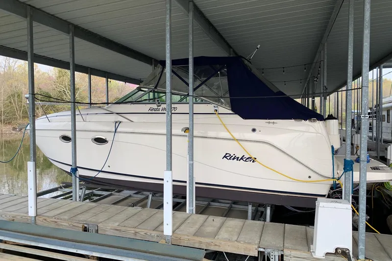 Slide: The Image of 2003 Rinker Fiesta Vee 270 boat docked under a covered marina. - 4