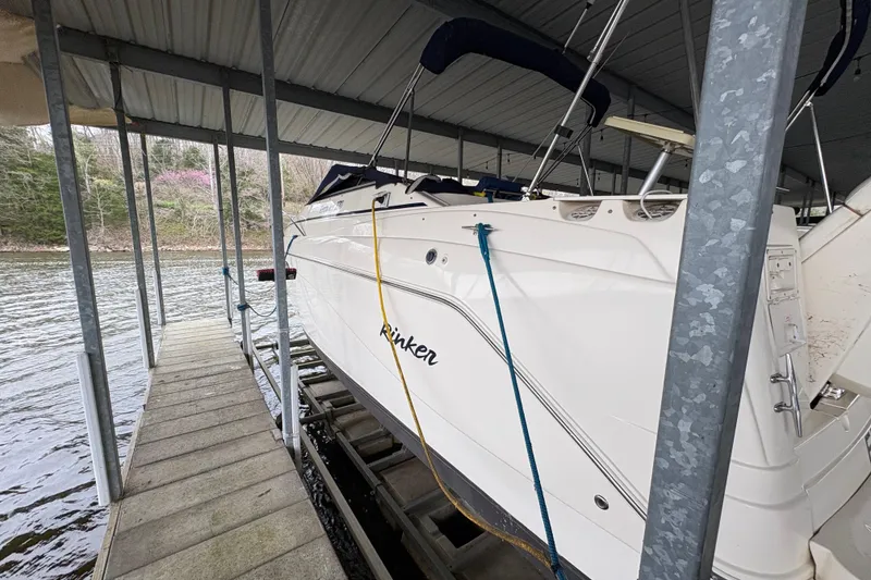 Slide: The Image of 2003 Rinker Fiesta Vee 270 boat docked under a covered marina. - 7