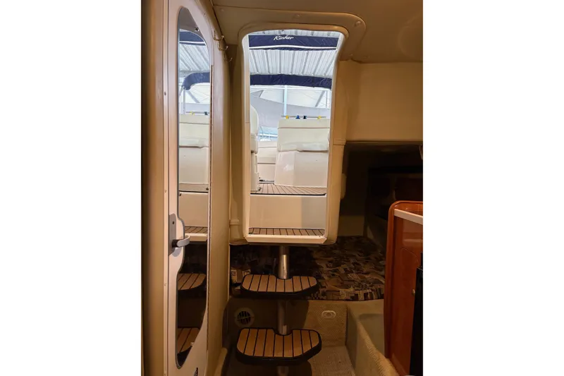 Slide: The Image of Interior view of 2003 Rinker Fiesta Vee 270 boat with steps leading outside. - 19