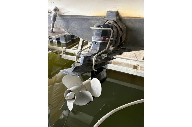Slide: The Image of 2003 Rinker Fiesta Vee 270 boat propeller and stern drive in water. - 10