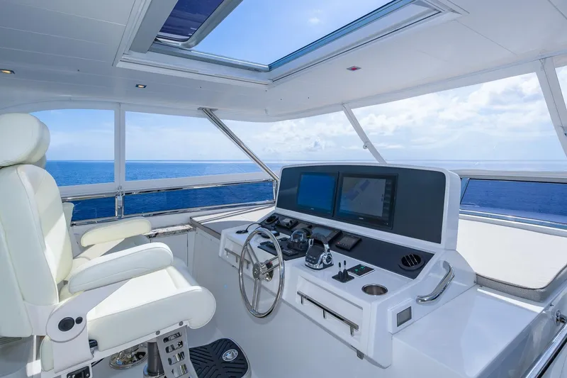 Slide: The Image of Luxurious 2019 Regency P65 yacht helm with ocean view, featuring modern navigation equipment. - 17