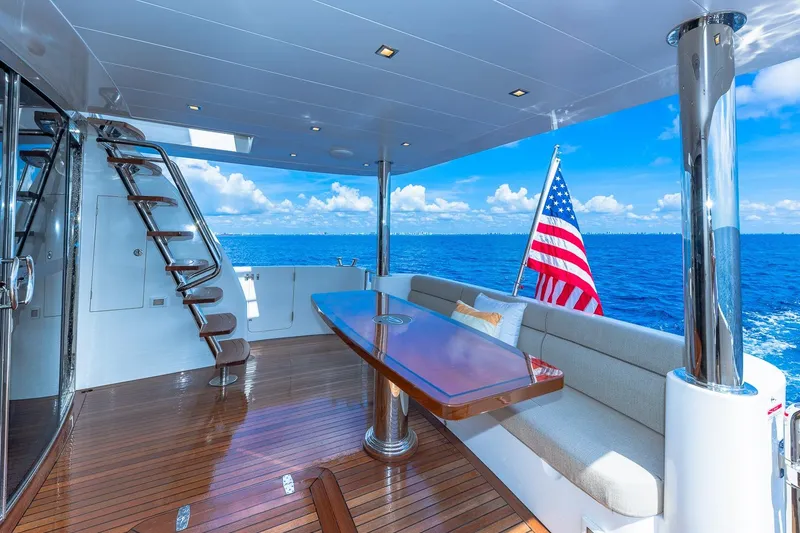 Slide: The Image of Luxurious Regency P65 yacht deck with seating, table, and ocean view, 2019 model. - 24