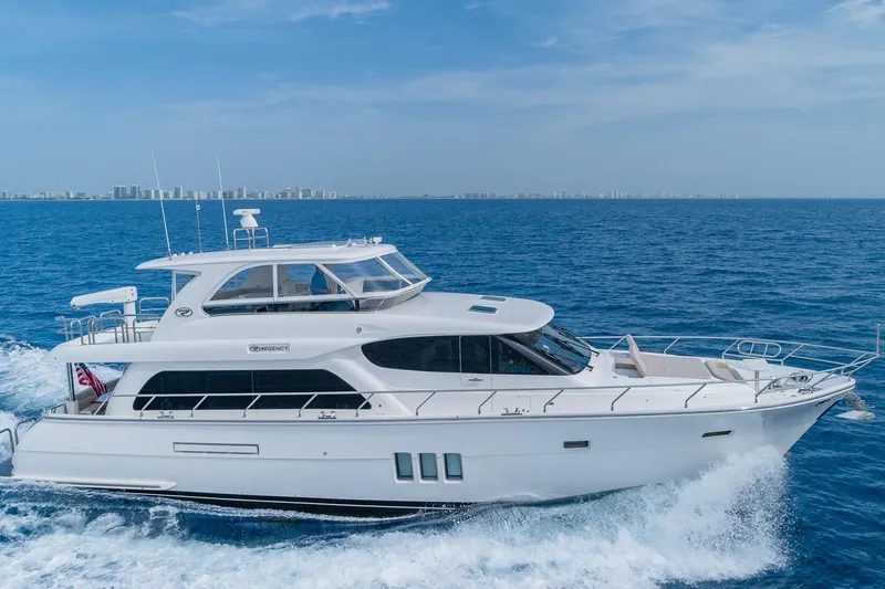 Slide: The Image of Luxurious 2019 Regency P65 yacht cruising on open blue sea. - 3