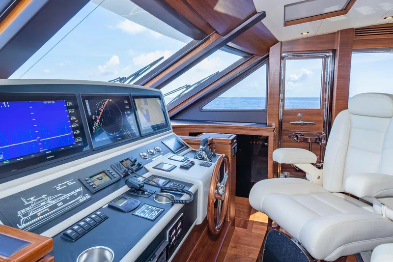 Slide: The Image of Luxurious 2019 Regency P65 yacht helm with advanced navigation systems and plush seating. - 34