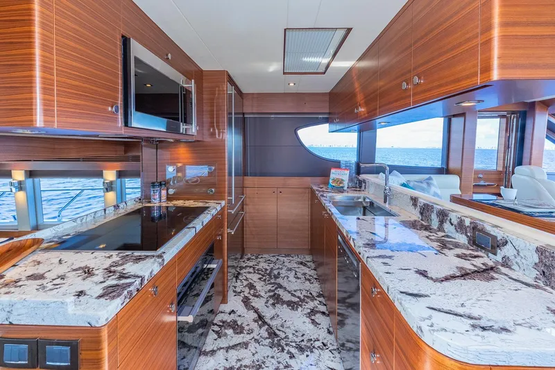 Slide: The Image of Luxurious kitchen interior on 2019 Regency P65 yacht with marble countertops and ocean view. - 40