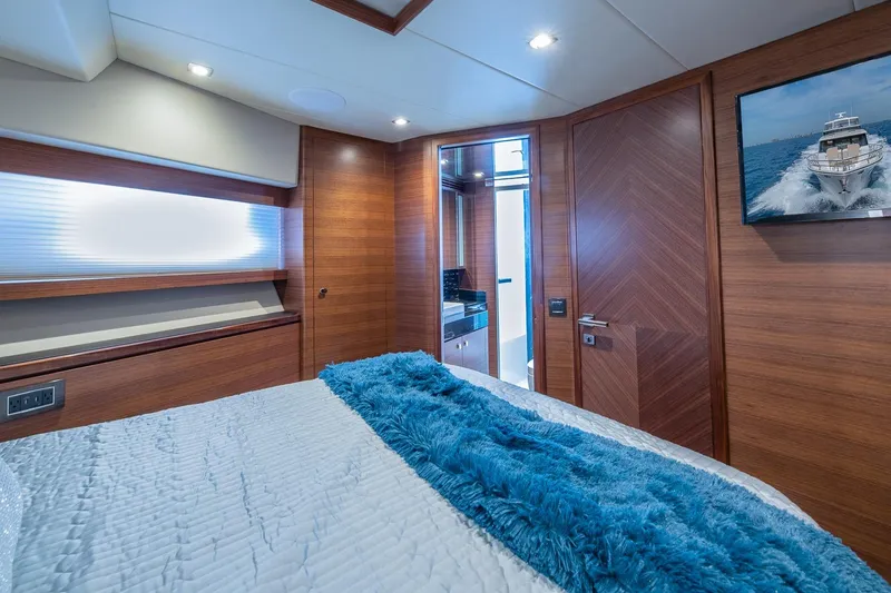 Slide: The Image of Luxurious Regency P65 2019 yacht bedroom with wood paneling and modern decor. - 42