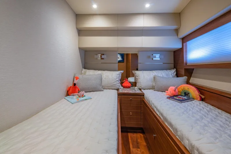 Slide: The Image of Luxurious twin cabin in 2019 Regency P65 yacht with plush bedding and decor. - 44