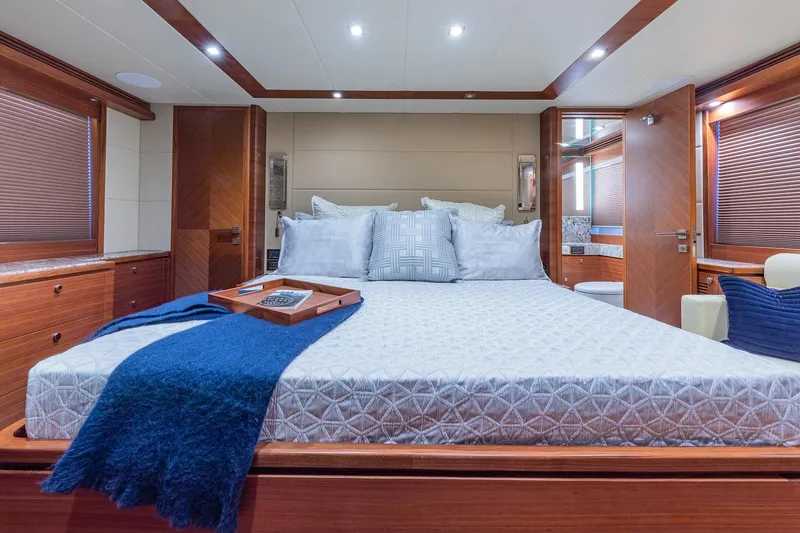 Slide: The Image of Luxurious bedroom interior of 2019 Regency P65 yacht with elegant wood finishes and plush bedding. - 46