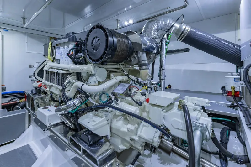 Slide: The Image of Engine room of 2019 Regency P65 yacht, showcasing complex machinery and components. - 55