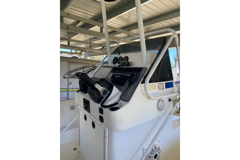 Slide: The Image of Console of a 2000 Novurania 21 boat with steering wheel and controls. - 13