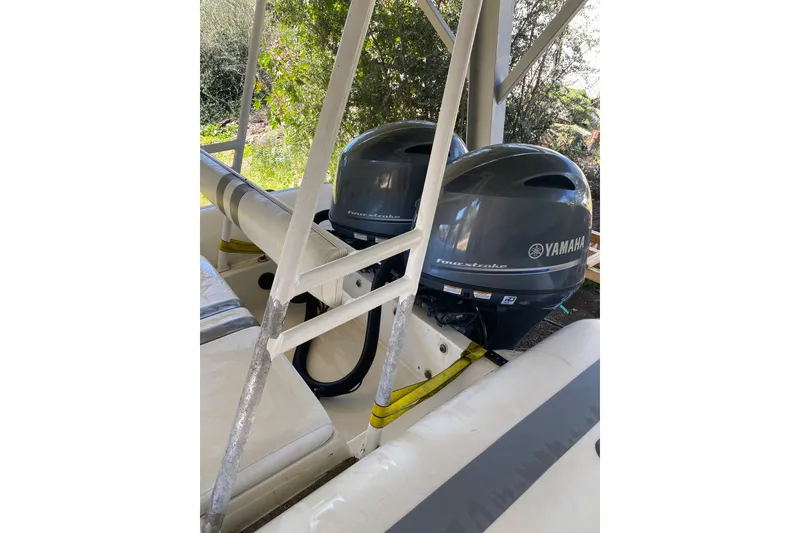 Slide: The Image of Novurania 21 boat with dual Yamaha outboard motors, 2000 model, under a canopy. - 15