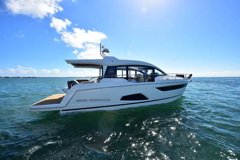 Slide: The Image of 2022 Sealine C430 yacht cruising on open water under a clear blue sky. - 15