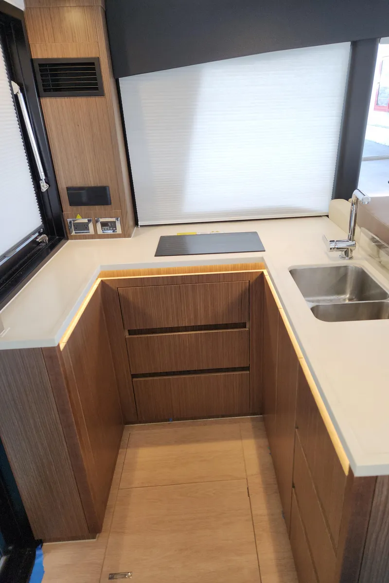 Slide: The Image of Modern kitchen interior of 2022 Sealine C430 yacht with sleek wood cabinetry and dual sinks. - 35