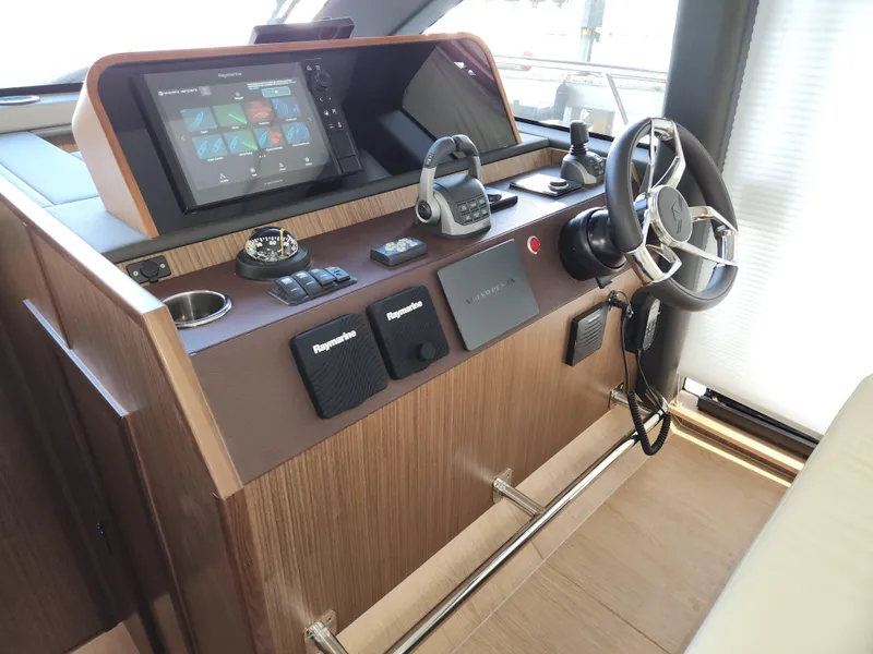 Slide: The Image of 2022 Sealine C430 yacht helm with modern navigation controls and steering wheel. - 38