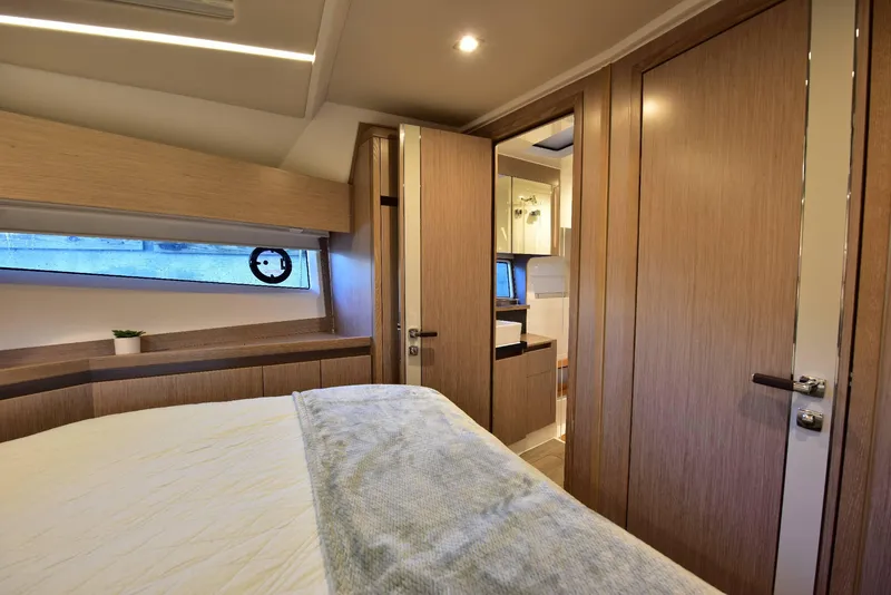 Slide: The Image of Luxurious interior of 2022 Sealine C430 yacht bedroom with modern wood finishes. - 46