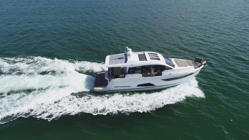 Slide: The Image of 2022 Sealine C430 yacht cruising on open water, aerial view. - 7