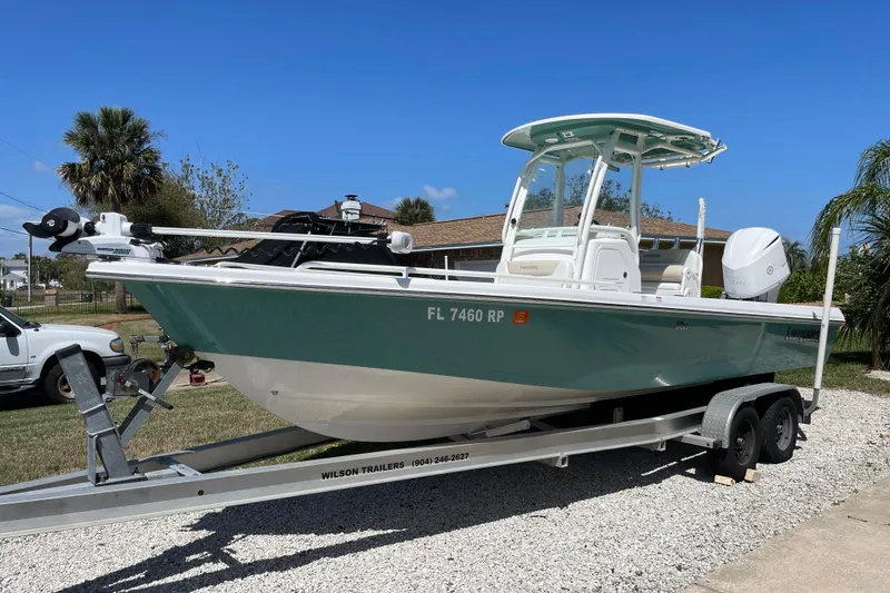 The Image of 2017 Everglades 243 Center Console boat on trailer, parked outdoors. - 1