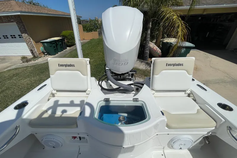 Slide: The Image of 2017 Everglades 243 Center Console boat with Yamaha engine, featuring seating and storage. - 11