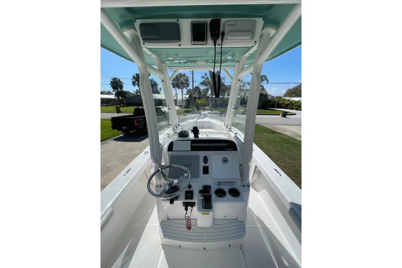 Slide: The Image of 2017 Everglades 243 Center Console boat interior with steering wheel and controls. - 9