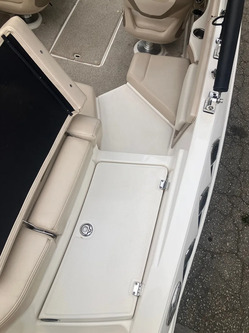 Slide: The Image of Interior of a 2011 Chaparral 216 SSi boat with beige seating. - 10