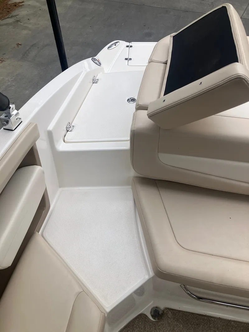 Slide: The Image of Interior of a 2011 Chaparral 216 SSi boat with beige seating. - 11