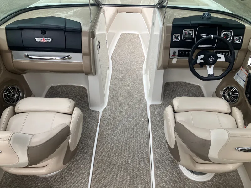 Slide: The Image of Interior of a 2011 Chaparral 216 SSi boat with steering wheel and seats. - 12