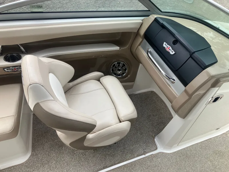 Slide: The Image of Interior of a 2011 Chaparral 216 SSi boat with beige seating. - 13