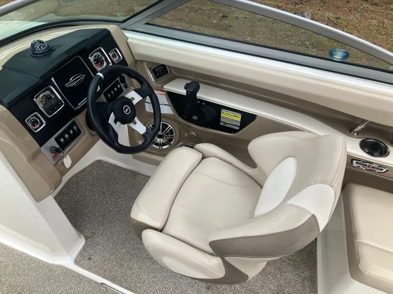 Slide: The Image of Interior of a 2011 Chaparral 216 SSi boat with steering console. - 15