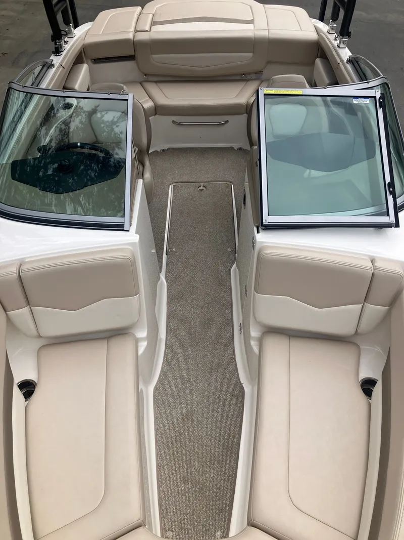 Slide: The Image of Interior of a 2011 Chaparral 216 SSi boat with beige seating. - 20