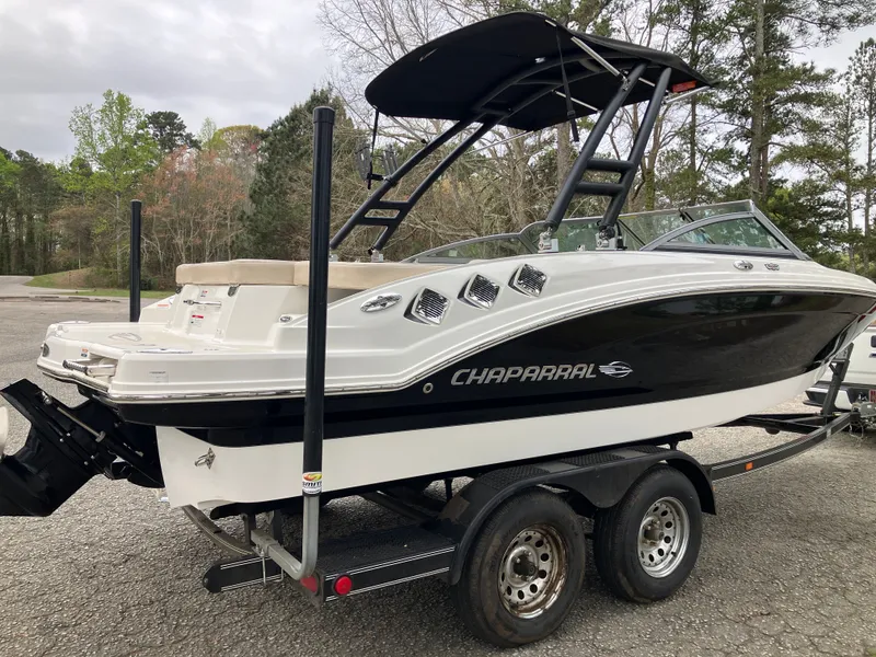 Slide: The Image of 2011 Chaparral 216 SSi boat parked on trailer outdoors. - 5
