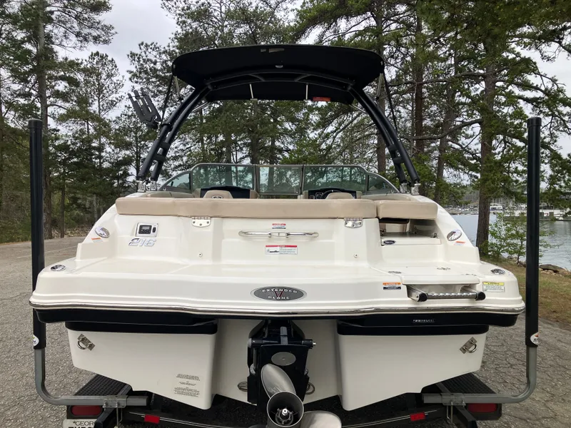 Slide: The Image of Rear view of a 2011 Chaparral 216 SSi boat outdoors. - 6