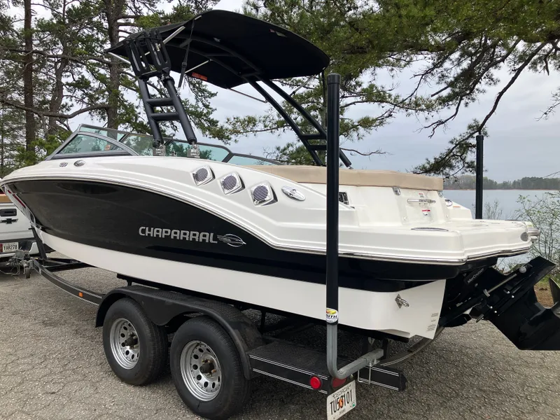 Slide: The Image of 2011 Chaparral 216 SSi boat on trailer, forest background. - 7
