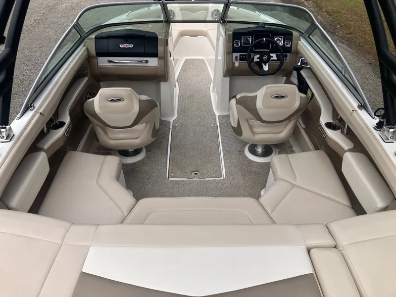 Slide: The Image of Interior of a 2011 Chaparral 216 SSi boat with beige seating. - 9